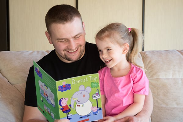 child-learning-about-dental-appointment-from-parent