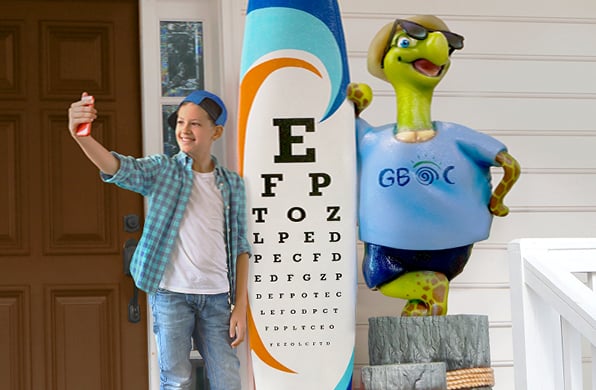 teen boy posing with surfboard photo op